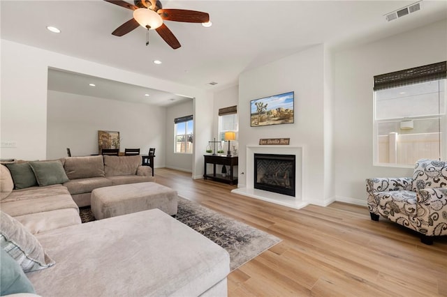 30644 Stage Coach Rd, Menifee, CA 92584 - living room with a ceiling fan, light wood finished floors, recessed lighting, and a glass covered fireplace