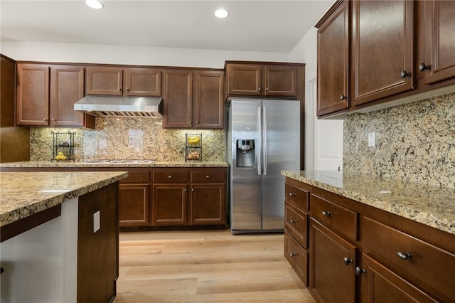 30644 Stage Coach Rd, Menifee, CA 92584 - kitchen with stainless steel fridge with ice dispenser, under cabinet range hood, backsplash, light wood-style floors, and recessed lighting