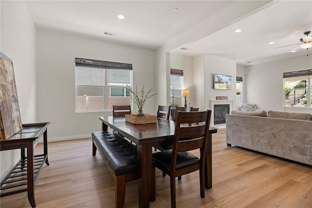 30644 Stage Coach Rd, Menifee, CA 92584 - dining space featuring a glass covered fireplace, light wood finished floors, ceiling fan, and recessed lighting