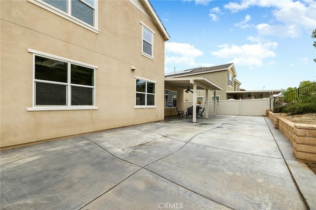 30644 Stage Coach Rd, Menifee, CA 92584 - back of house with stucco siding, a patio, a fenced backyard, outdoor dining area, and ceiling fan
