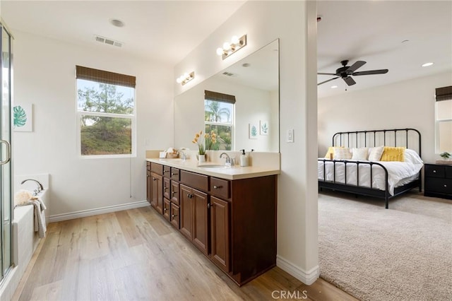 30644 Stage Coach Rd, Menifee, CA 92584 - ensuite bathroom featuring double vanity, wood finished floors, ceiling fan, a bath, and recessed lighting