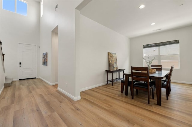 30644 Stage Coach Rd, Menifee, CA 92584 - dining area with light wood-style floors, recessed lighting, and a towering ceiling