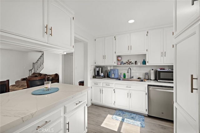 4292 Howard Ave, Los Alamitos, CA 90720 - kitchen with dishwasher, decorative backsplash, recessed lighting, light stone counters, and white cabinetry