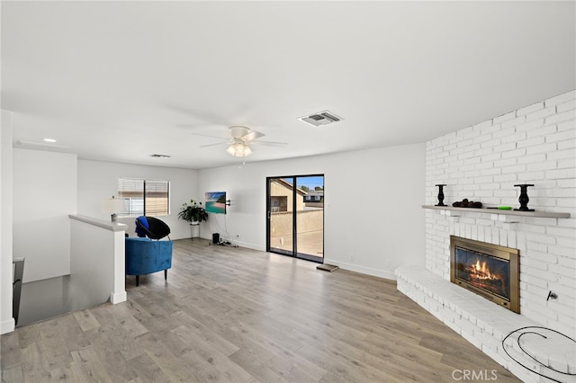 4292 Howard Ave, Los Alamitos, CA 90720 - unfurnished living room featuring ceiling fan, wood finished floors, and a fireplace