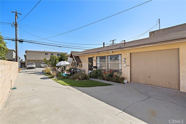 4292 Howard Ave, Los Alamitos, CA 90720 - view of front of home with stucco siding, a garage, and driveway
