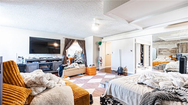 3375 Fuchsia, Costa Mesa, CA 92626 - bedroom featuring a textured ceiling and a glass covered fireplace