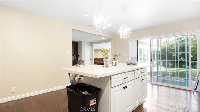 3375 Fuchsia, Costa Mesa, CA 92626 - kitchen featuring a chandelier, wood finished floors, white cabinetry, light countertops, and hanging light fixtures