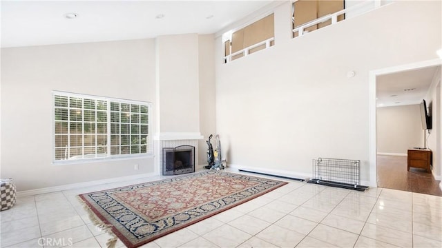 3375 Fuchsia, Costa Mesa, CA 92626 - unfurnished living room with a high ceiling, tile patterned floors, and a fireplace