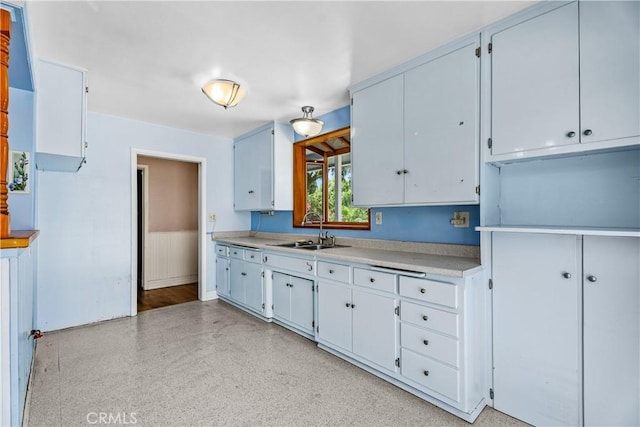 1920 Faust Ave, Long Beach, CA 90815 - kitchen featuring light countertops, wainscoting, and white cabinetry