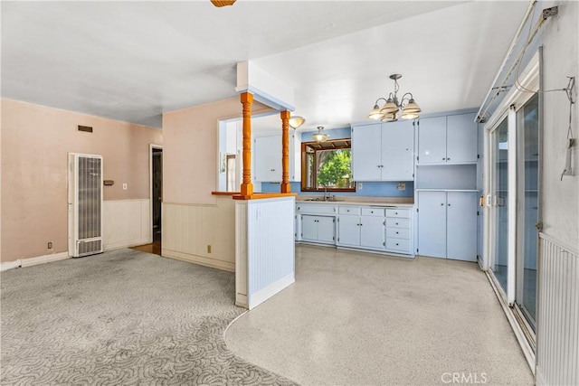 1920 Faust Ave, Long Beach, CA 90815 - kitchen featuring a heating unit, a wainscoted wall, a chandelier, pendant lighting, and light countertops