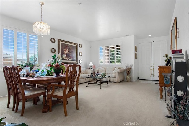 15029 Coyote Ct, Fontana, CA 92336 - dining space featuring light colored carpet and a chandelier