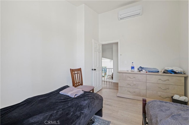 12616 Terra Bella St, Pacoima, CA 91331 - bedroom featuring a wall mounted AC, a high ceiling, and light wood-style floors