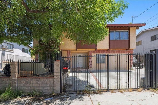 12616 Terra Bella St, Pacoima, CA 91331 - townhome / multi-family property featuring brick siding, stucco siding, and a fenced front yard