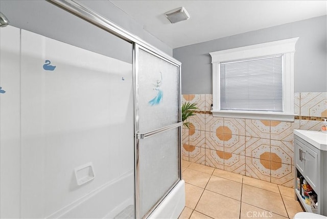 1665 Arlington Ave, Los Angeles, CA 90019 - full bath with tile walls, vanity, wainscoting, combined bath / shower with glass door, and tile patterned floors