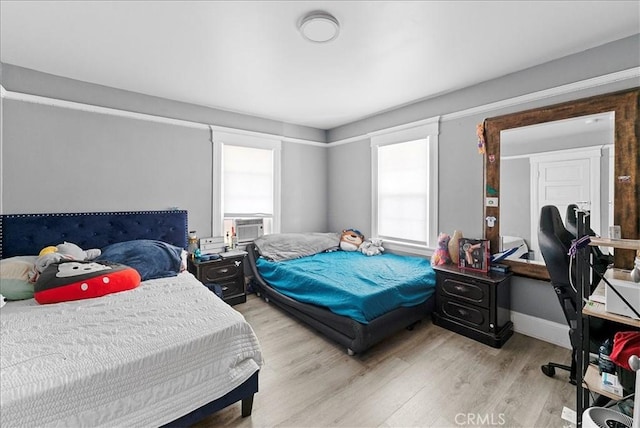 1665 Arlington Ave, Los Angeles, CA 90019 - bedroom with light wood-style flooring and cooling unit