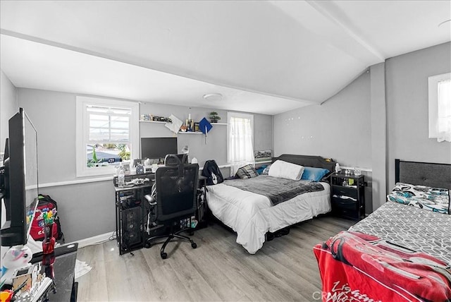 1665 Arlington Ave, Los Angeles, CA 90019 - bedroom with multiple windows, wood finished floors, and vaulted ceiling