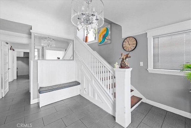 1665 Arlington Ave, Los Angeles, CA 90019 - stairway with a chandelier, healthy amount of natural light, and tile patterned floors