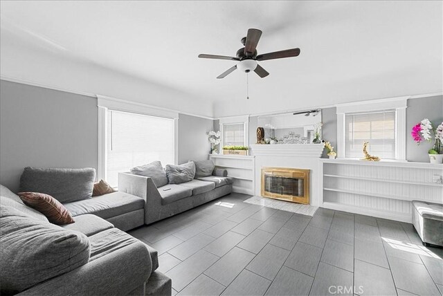 1665 Arlington Ave, Los Angeles, CA 90019 - living area featuring ceiling fan and a glass covered fireplace