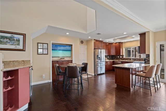 533 Roswell Ave, Long Beach, CA 90814 - kitchen featuring appliances with stainless steel finishes, a kitchen breakfast bar, a peninsula, dark wood-style flooring, and ornamental molding