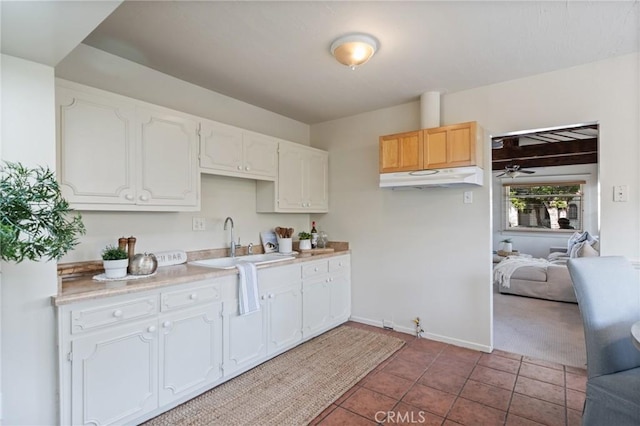 533 Roswell Ave, Long Beach, CA 90814 - kitchen featuring under cabinet range hood, a ceiling fan, white cabinets, light countertops, and tile patterned floors