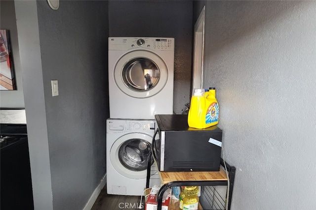 8110 S Denker Ave, Los Angeles, CA 90047 - laundry room with estacked washer and dryer, wood finished floors, and a textured wall