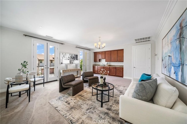 53 Interlude, Irvine, CA 92620 - living room featuring light colored carpet, a chandelier, crown molding, and french doors
