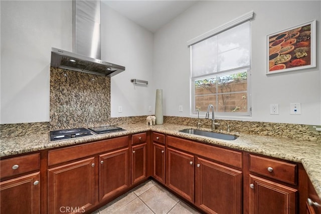 53 Interlude, Irvine, CA 92620 - kitchen with wall chimney exhaust hood, stainless steel gas cooktop, light tile patterned floors, light stone counters, and reddish brown cabinets