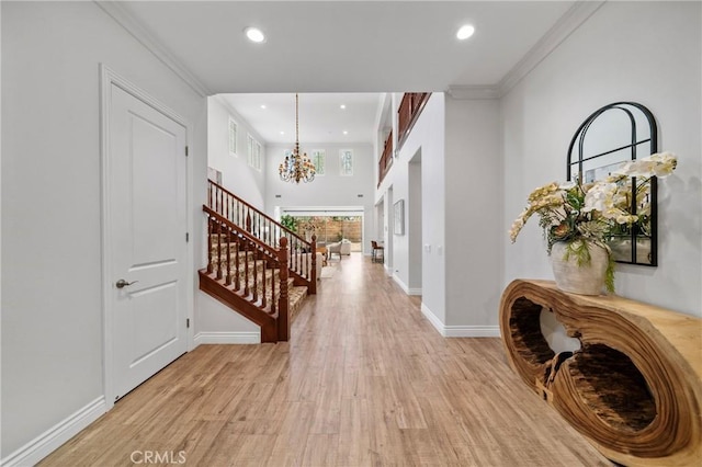 53 Interlude, Irvine, CA 92620 - foyer with a chandelier, stairs, light wood-style flooring, recessed lighting, and ornamental molding