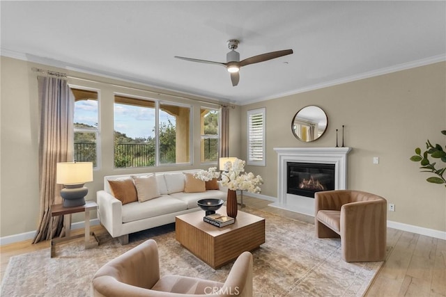 24912 Hearth Ct, Valencia, CA 91354 - living area with ornamental molding, light wood-type flooring, a glass covered fireplace, and a ceiling fan