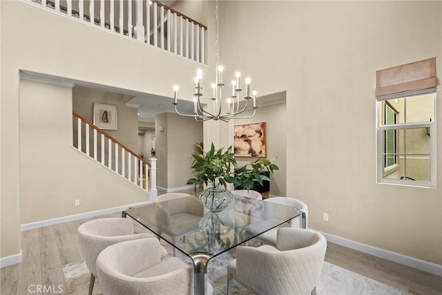 24912 Hearth Ct, Valencia, CA 91354 - dining space with wood finished floors, a high ceiling, a chandelier, and stairway