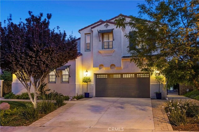 24912 Hearth Ct, Valencia, CA 91354 - mediterranean / spanish-style home with a garage, concrete driveway, and stucco siding
