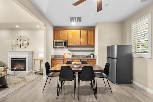 24912 Hearth Ct, Valencia, CA 91354 - kitchen featuring appliances with stainless steel finishes, ceiling fan, light wood-type flooring, recessed lighting, and a glass covered fireplace