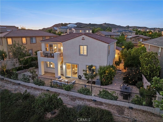 24912 Hearth Ct, Valencia, CA 91354 - view of front of property featuring a balcony, a patio, a fenced backyard, a tiled roof, and stucco siding