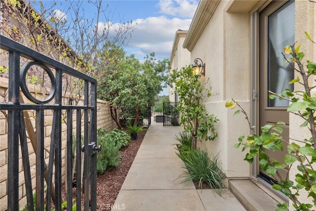 24912 Hearth Ct, Valencia, CA 91354 - view of side of property with a gate and stucco siding