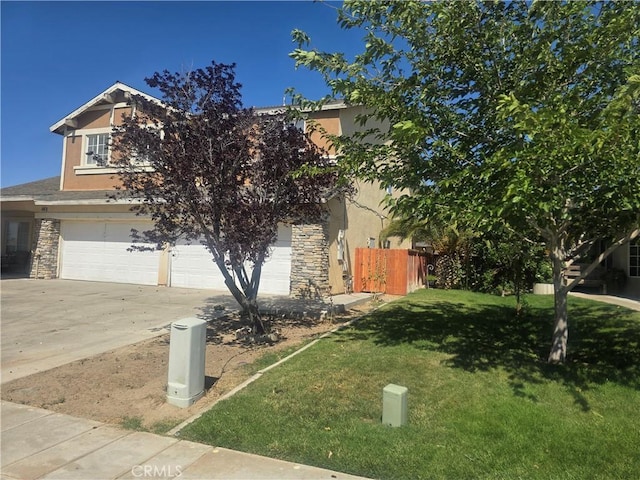 14693 Karen Dr, Victorville, CA 92394 - view of property hidden behind natural elements with stucco siding, stone siding, an attached garage, and driveway