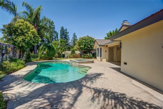 9425 Oak Hills Ave, Bakersfield, CA 93312 - view of pool with a patio, a fenced backyard, and a pool with connected hot tub