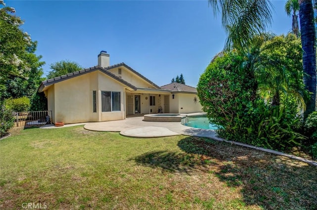 9425 Oak Hills Ave, Bakersfield, CA 93312 - back of property with stucco siding, a patio, a chimney, and a pool with connected hot tub