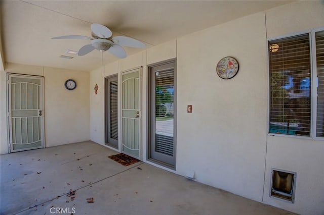9425 Oak Hills Ave, Bakersfield, CA 93312 - view of exterior entry with ceiling fan, a patio, and stucco siding