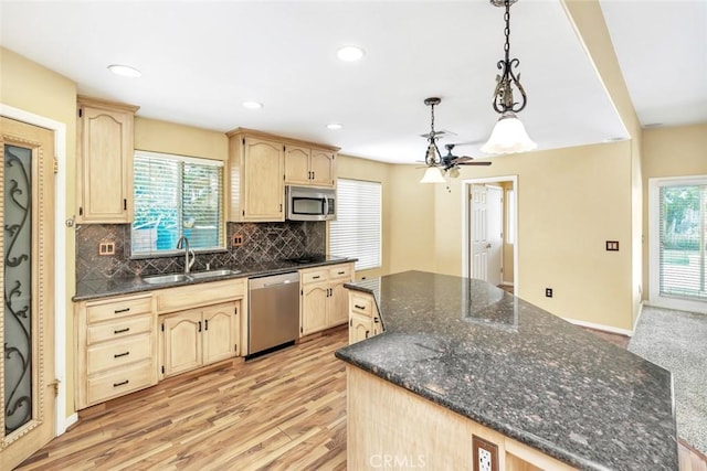 9425 Oak Hills Ave, Bakersfield, CA 93312 - kitchen featuring appliances with stainless steel finishes, a kitchen island, light brown cabinetry, plenty of natural light, and recessed lighting