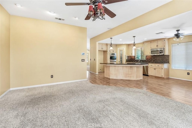 9425 Oak Hills Ave, Bakersfield, CA 93312 - kitchen with light brown cabinetry, a ceiling fan, stainless steel appliances, dark countertops, and recessed lighting