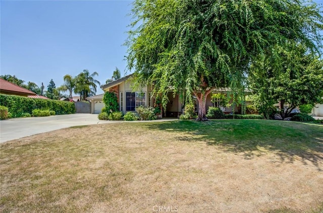 9425 Oak Hills Ave, Bakersfield, CA 93312 - view of front of house with concrete driveway, an attached garage, and a front lawn