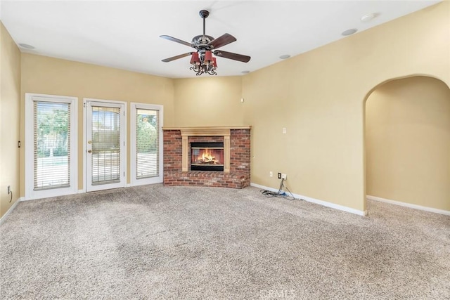 9425 Oak Hills Ave, Bakersfield, CA 93312 - unfurnished living room featuring a ceiling fan, carpet, a fireplace, and arched walkways