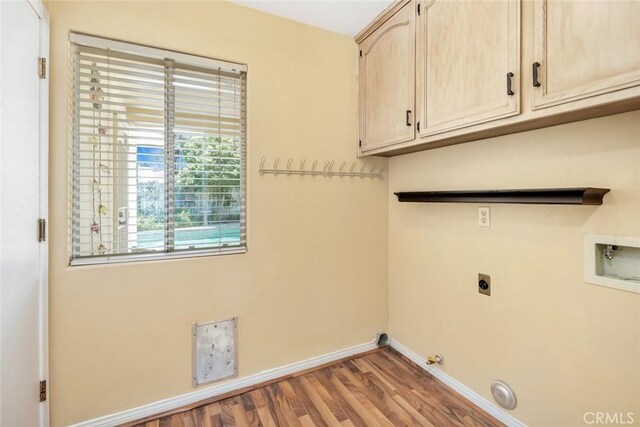 9425 Oak Hills Ave, Bakersfield, CA 93312 - laundry room featuring cabinet space, hookup for an electric dryer, gas dryer hookup, wood finished floors, and hookup for a washing machine