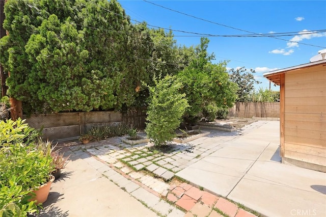 13162 Oaks Ave, Chino, CA 91710 - fenced backyard with a patio area and a vegetable garden