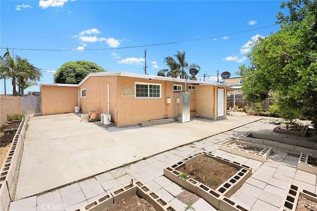 13162 Oaks Ave, Chino, CA 91710 - back of house with a garden, a patio, stucco siding, and a fenced backyard