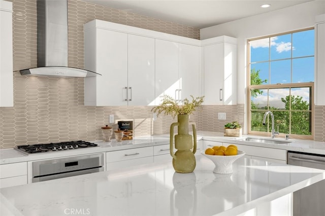 100 Soaring Eagle, Irvine, CA 92618 - kitchen featuring wall chimney exhaust hood, stainless steel appliances, plenty of natural light, white cabinets, and recessed lighting