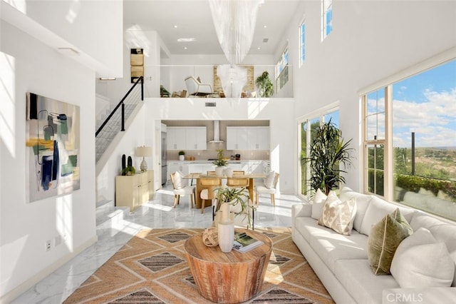 100 Soaring Eagle, Irvine, CA 92618 - living area featuring a high ceiling, stairs, light marble finish floors, a chandelier, and recessed lighting