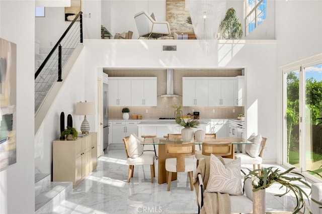 100 Soaring Eagle, Irvine, CA 92618 - dining area featuring a towering ceiling, stairway, and light marble finish flooring