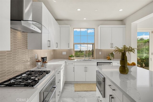 100 Soaring Eagle, Irvine, CA 92618 - kitchen with wall chimney exhaust hood, stainless steel appliances, recessed lighting, healthy amount of natural light, and white cabinetry