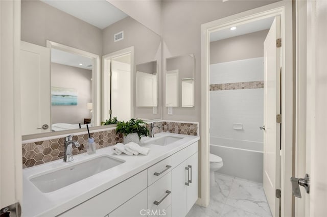 100 Soaring Eagle, Irvine, CA 92618 - full bathroom featuring double vanity, marble look tiles, and backsplash